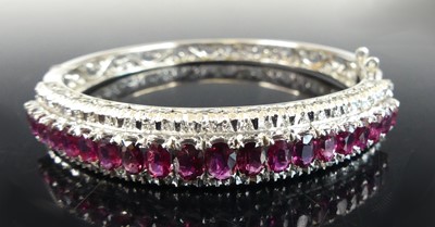 Lot 2886 - A white metal ruby and diamond hinged oval...
