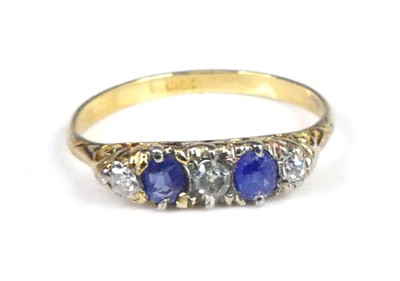 Lot 2899 - A yellow metal, sapphire and diamond carved...
