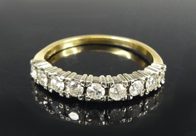 Lot 2915 - An 18ct gold and platinum diamond half...