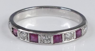 Lot 2931 - A white metal ruby & diamond set half eternity...