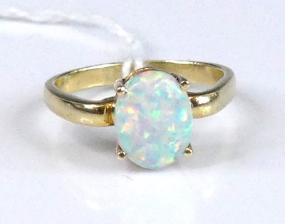 Lot 2957 - A modern 14ct gold and opal set dress ring,...