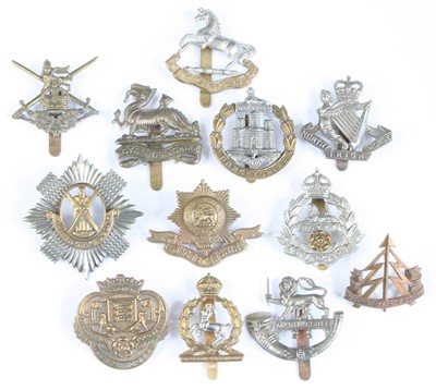 Lot 558 - A collection of assorted cap badges and...