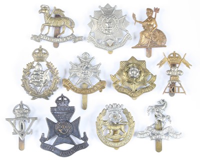 Lot 559 - A collection of assorted cap badges and...