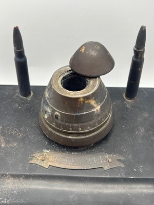 Lot 652 - A WWI trench art inkwell, a brass fuse hinged...