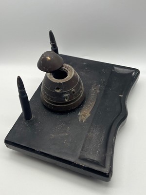 Lot 652 - A WWI trench art inkwell, a brass fuse hinged...