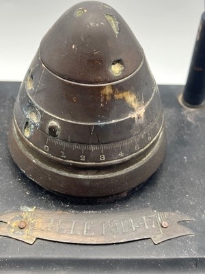 Lot 652 - A WWI trench art inkwell, a brass fuse hinged...