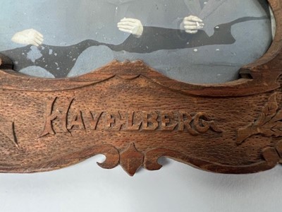 Lot 662 - A wooden photo frame with carved decoration...