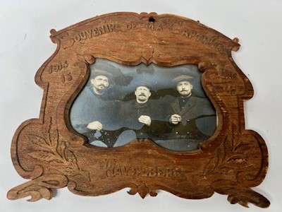 Lot 662 - A wooden photo frame with carved decoration...