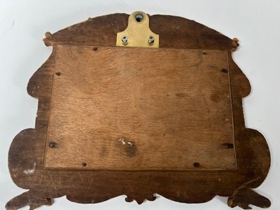 Lot 662 - A wooden photo frame with carved decoration...