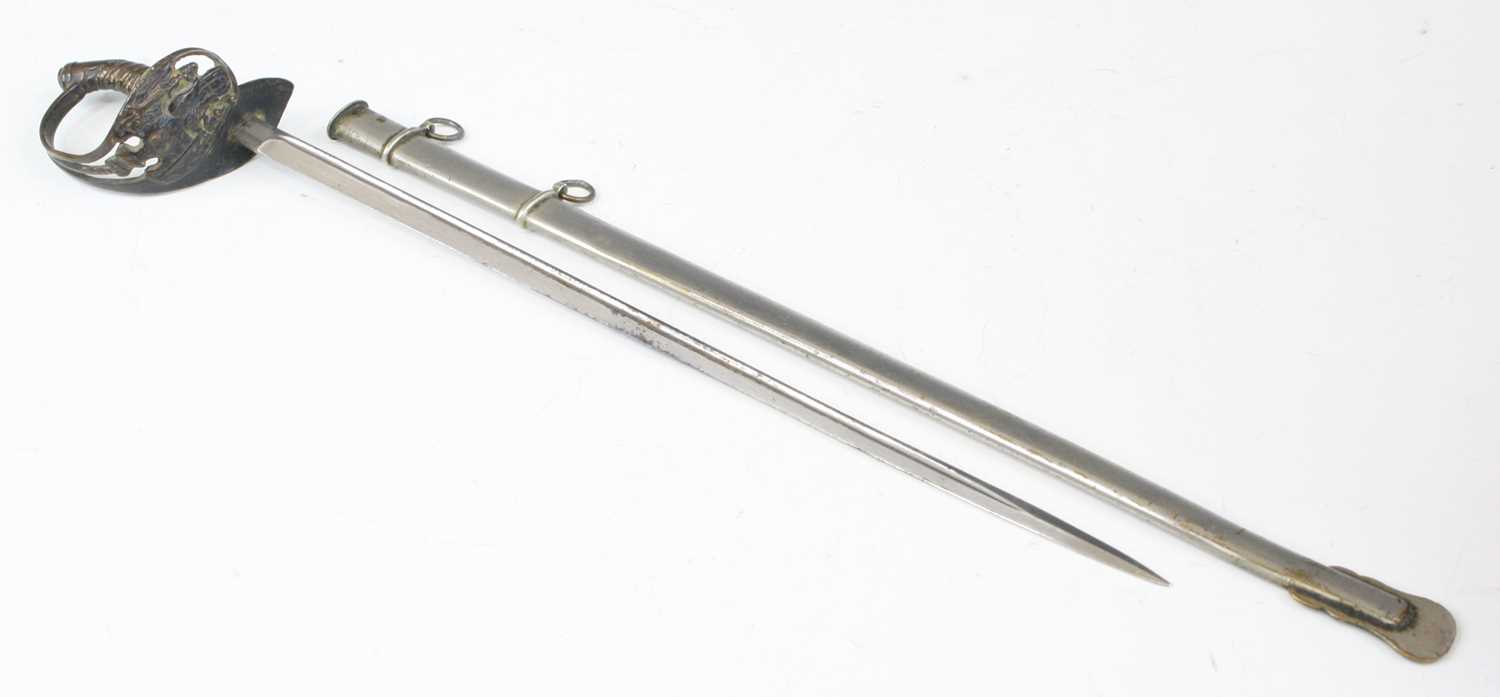 Lot 669 - A letter opener in the form of a German sword...