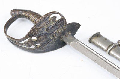 Lot 669 - A letter opener in the form of a German sword...