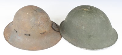 Lot 575 - A WW II Brodie pattern steel helmet, having a...