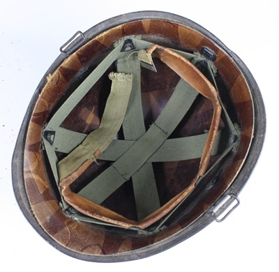 Lot 673 - An American M1 steel combat helmet, having a...