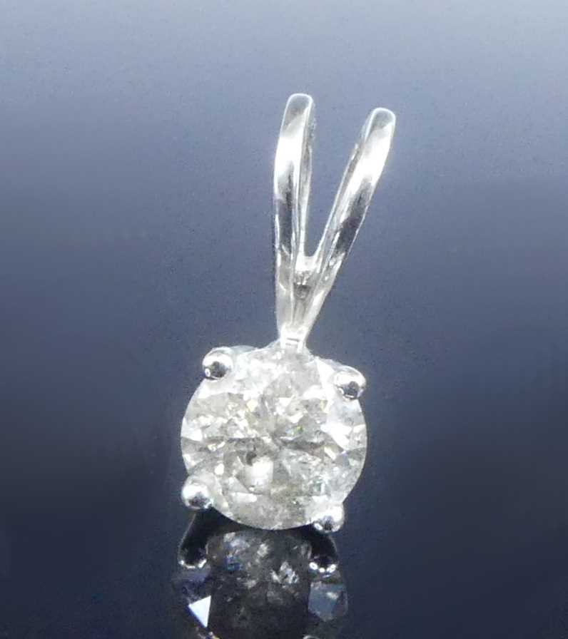 Lot 2622 - An 18ct white gold single stone pendant,...