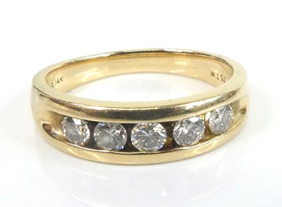 Lot 2630 - A yellow metal diamond half eternity ring,...