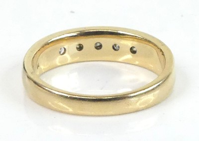 Lot 2630 - A yellow metal diamond half eternity ring,...
