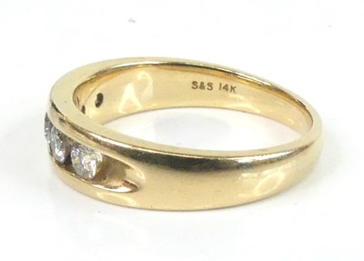 Lot 2630 - A yellow metal diamond half eternity ring,...