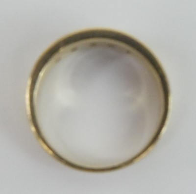 Lot 2630 - A yellow metal diamond half eternity ring,...