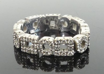 Lot 2632 - A white metal diamond eternity ring, featuring...