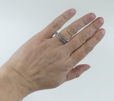 Lot 2632 - A white metal diamond eternity ring, featuring...