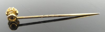 Lot 2606 - A yellow metal diamond stick pin, featuring an...