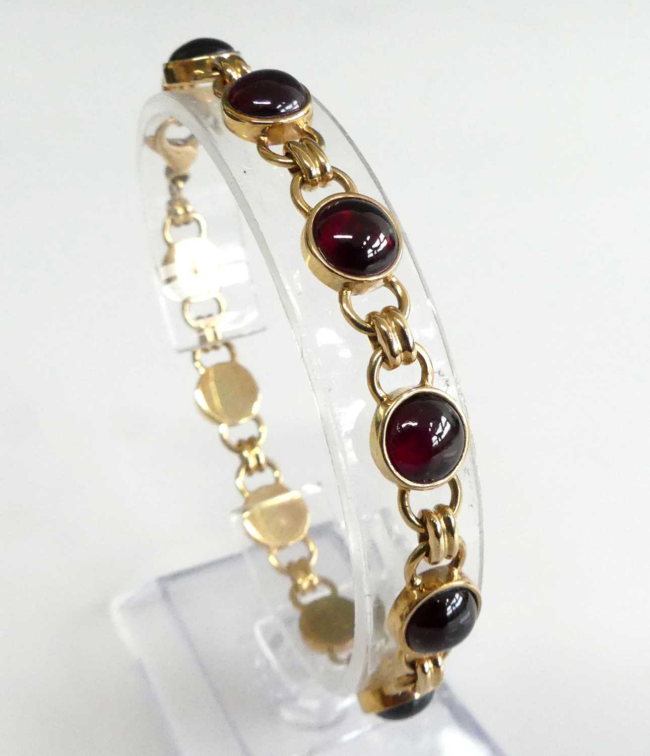 Lot 2599 - A 9ct gold cabochon garnet set bracelet,...