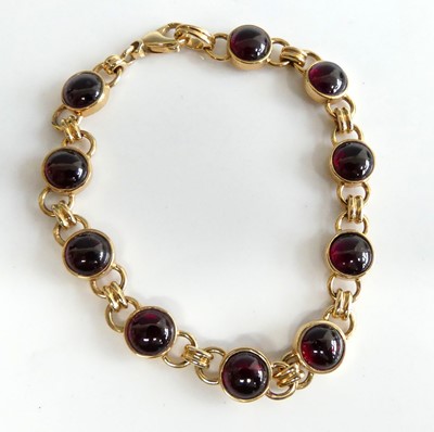 Lot 2599 - A 9ct gold cabochon garnet set bracelet,...