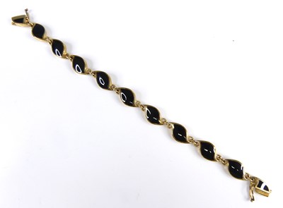 Lot 2617 - A contemporary 9ct gold and polished black...