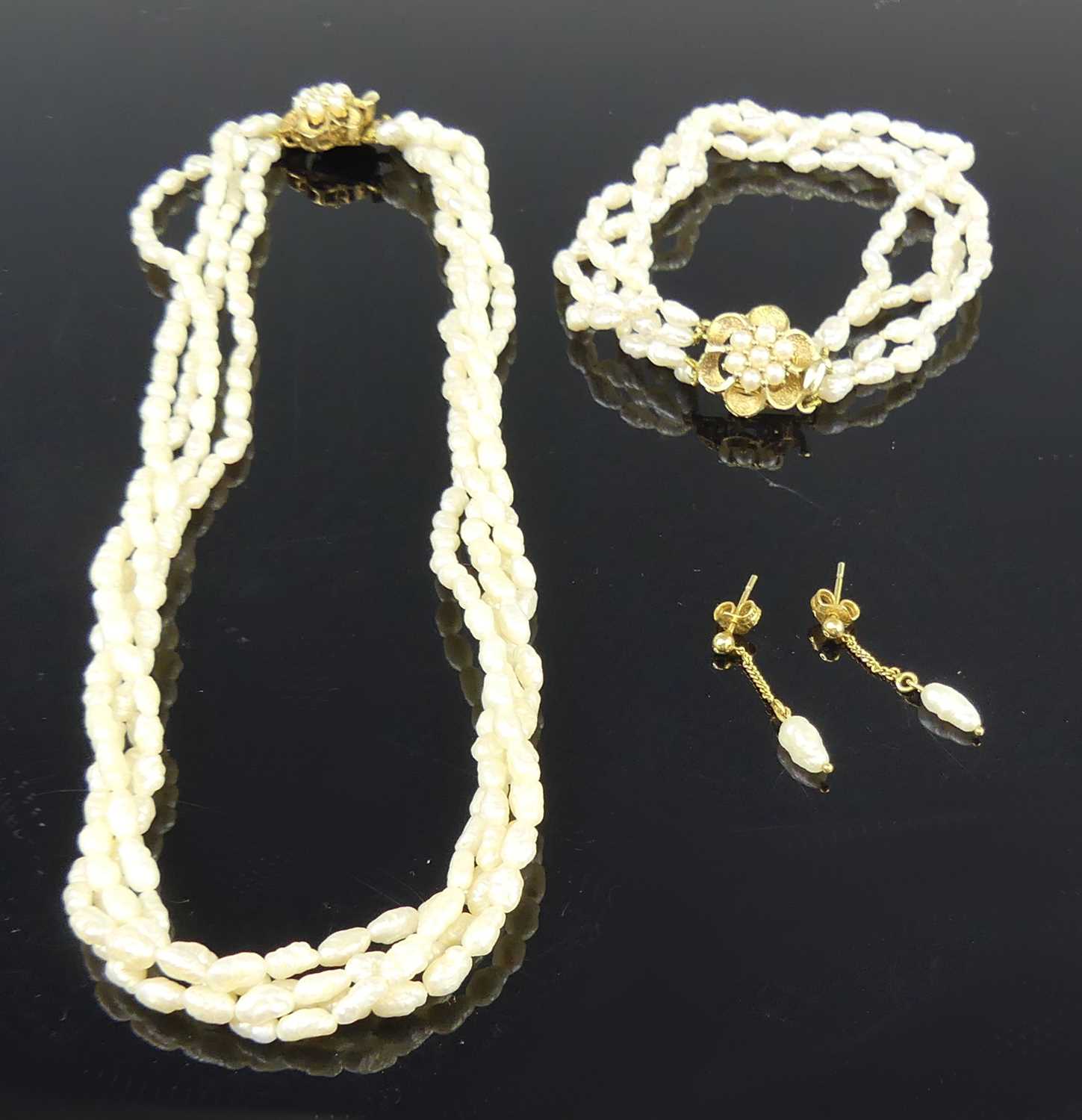 Lot 2628 - A contemporary rice pearl choker, arranged as...