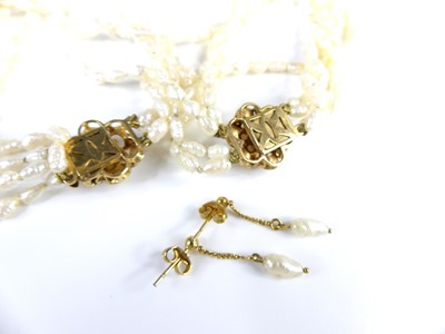 Lot 2628 - A contemporary rice pearl choker, arranged as...