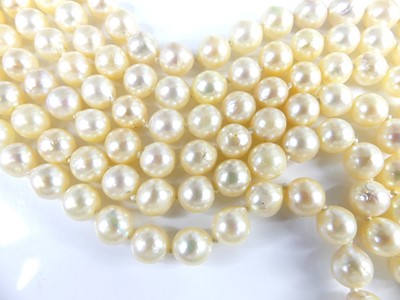 Lot 2609 - A cultured pearl triple string choker, the...