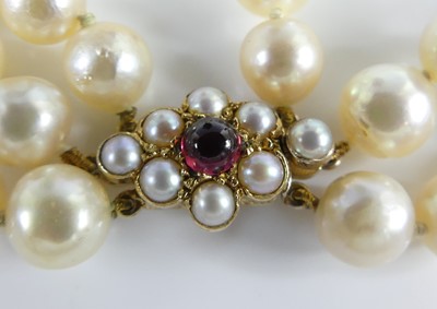 Lot 2609 - A cultured pearl triple string choker, the...