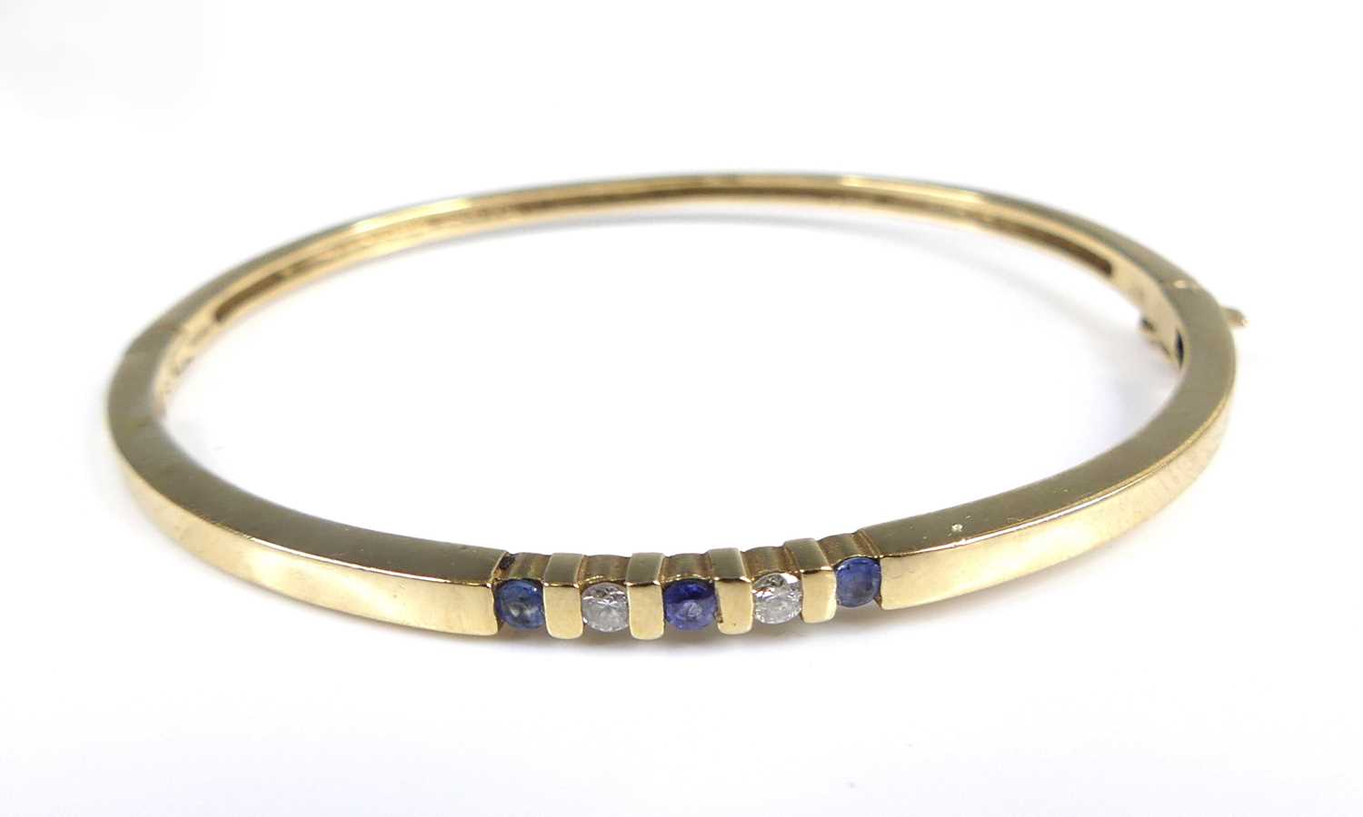 Lot 2651 - A 9ct gold sapphire and diamond set hinge...