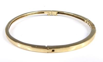 Lot 2651 - A 9ct gold sapphire and diamond set hinge...