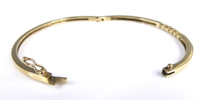 Lot 2651 - A 9ct gold sapphire and diamond set hinge...