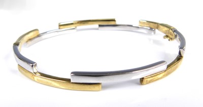Lot 2612 - A contemporary 9ct yellow and white gold hinge...