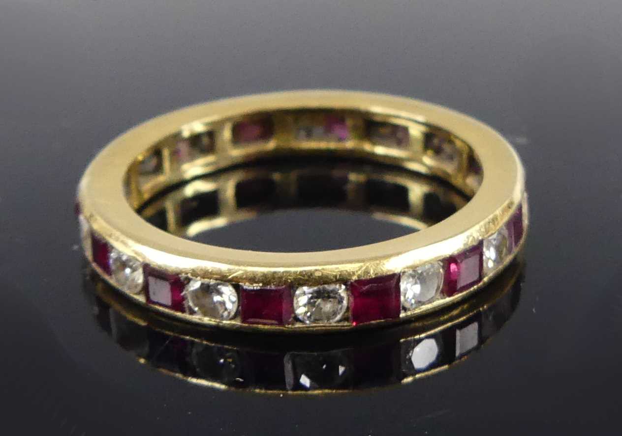 Lot 2675 - A yellow metal ruby and diamond eternity ring...