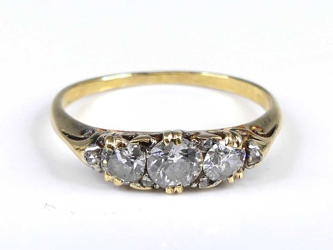 Lot 2687 - A yellow metal diamond 3 stone ring featuring...