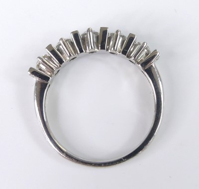 Lot 2518 - An 18ct white gold diamond half eternity ring...