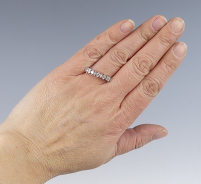Lot 2518 - An 18ct white gold diamond half eternity ring...