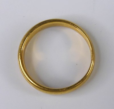 Lot 2584 - A 22ct gold 3.5mm court shaped wedding band,...