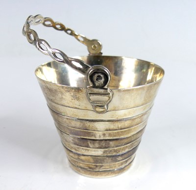Lot 2074 - A George II silver gilt swing-handled table...
