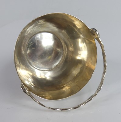 Lot 2074 - A George II silver gilt swing-handled table...