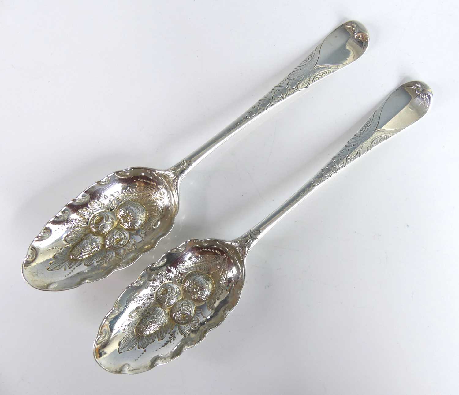 Lot 2065 - A pair of George II silver berry spoons,...