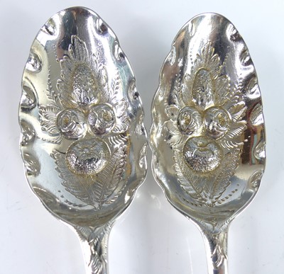 Lot 2065 - A pair of George II silver berry spoons,...