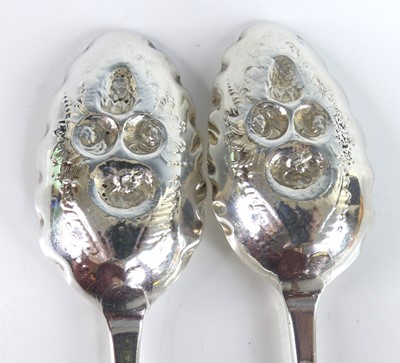 Lot 2065 - A pair of George II silver berry spoons,...