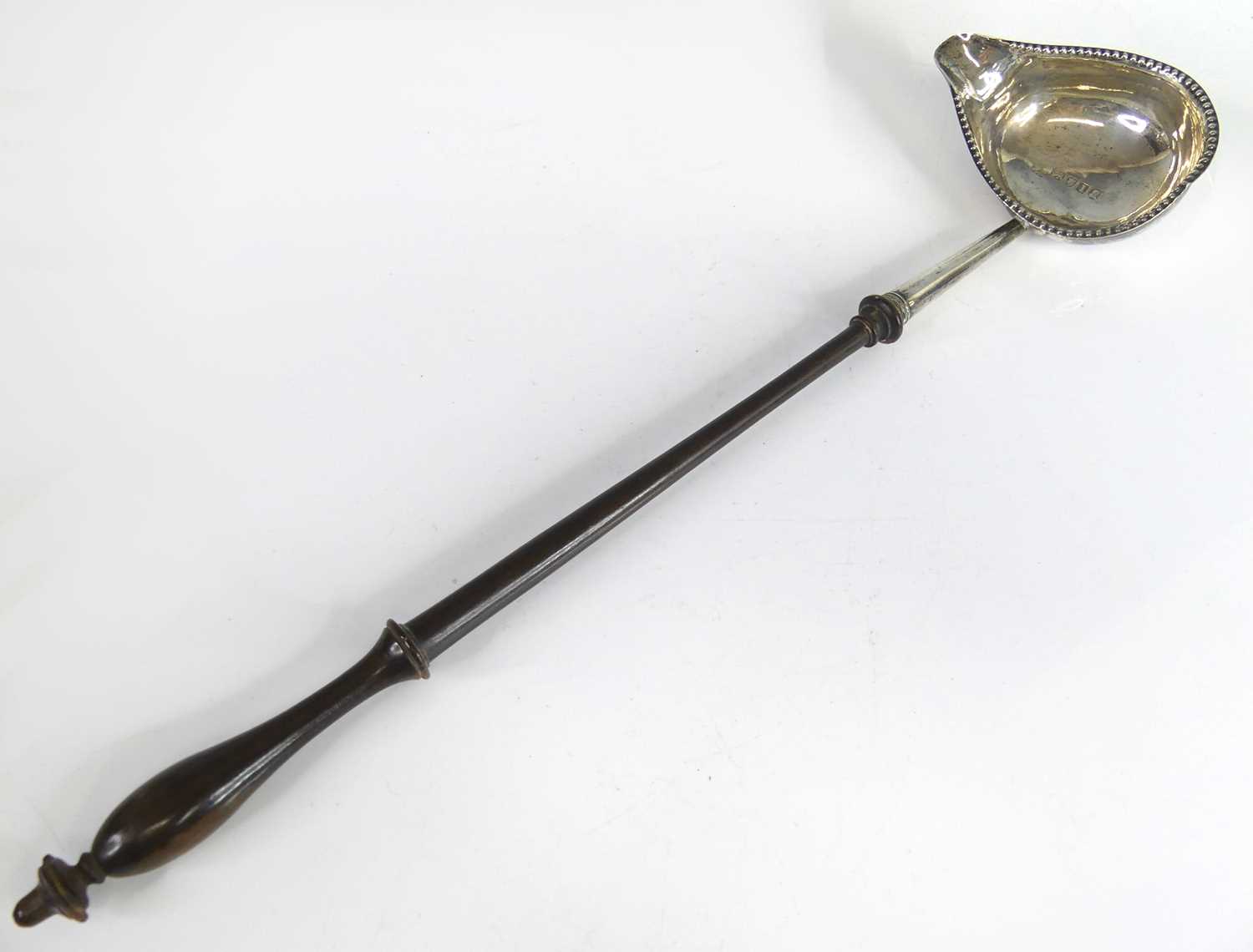Lot 2070 - A George III silver toddy ladle, having...