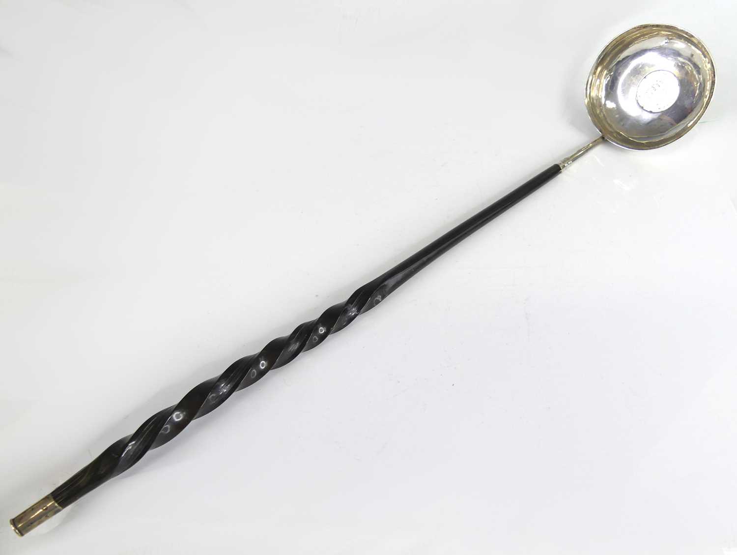 Lot 2069 - A George III white metal toddy ladle, having a...