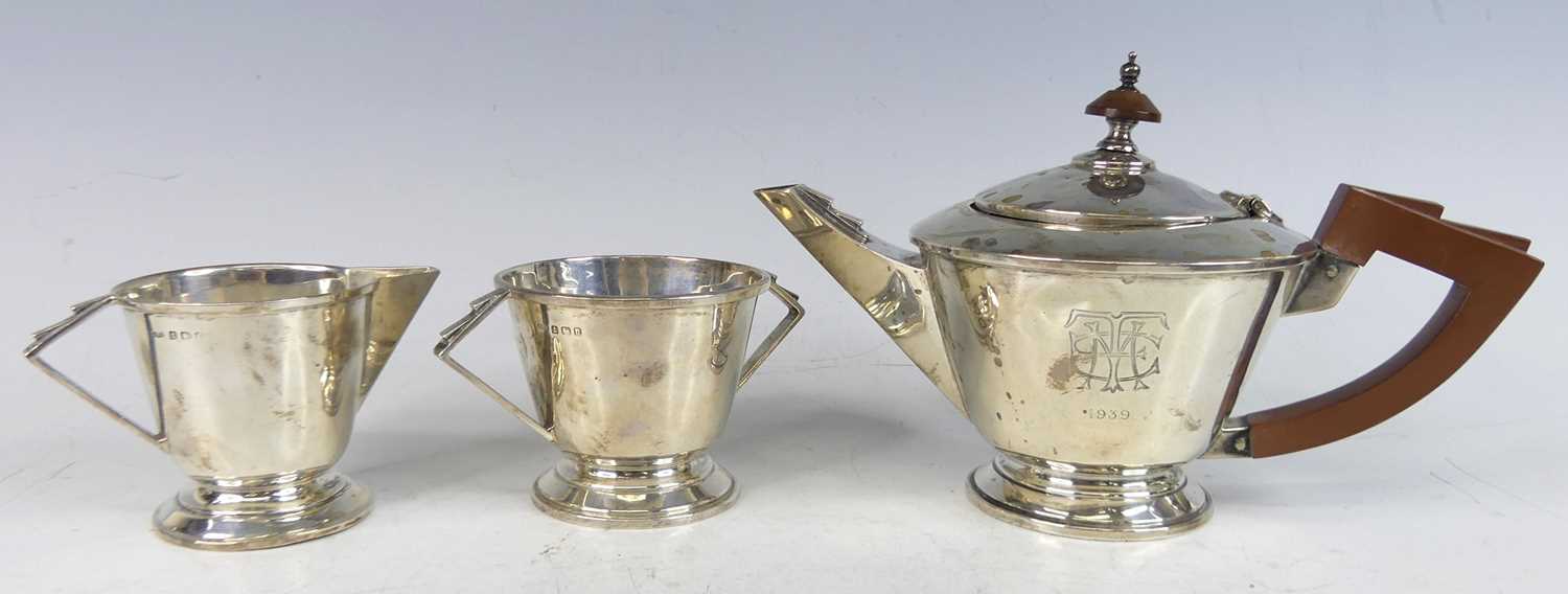 Lot 102 - An Art Deco silver bachelors three-piece tea...