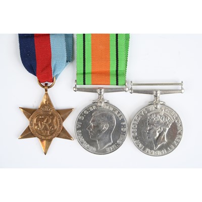 Lot 21 - A group of three WW II medals to include...